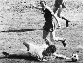 German player Paul Breitner fells in front of Polish player Grzegorz Lato in a slippery football field during the German 1974 World Cup in Frankfurt on July 03, 1974.