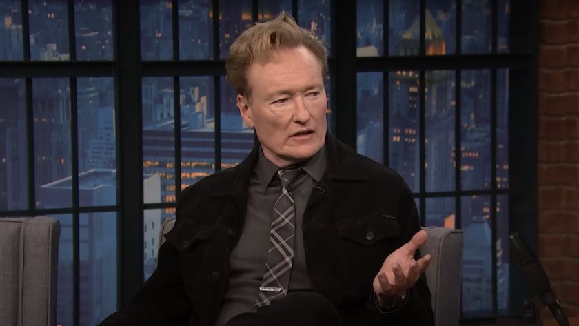 Conan O&#039;Brien speaking with Seth Meyers on Late Night