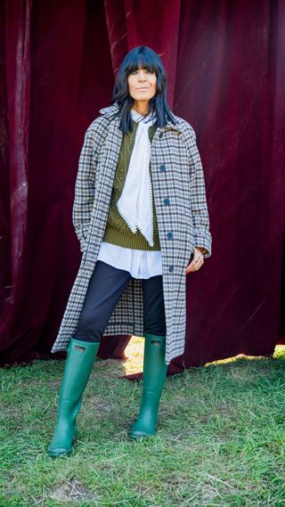 Claudia Winkleman in a check coat and wellies