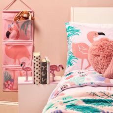 bedroom with printed flamingos and plants bedding set