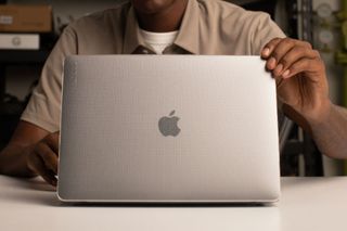 A person using the Apple Incase MacBook hardshell case, one of the best MacBook Air cases