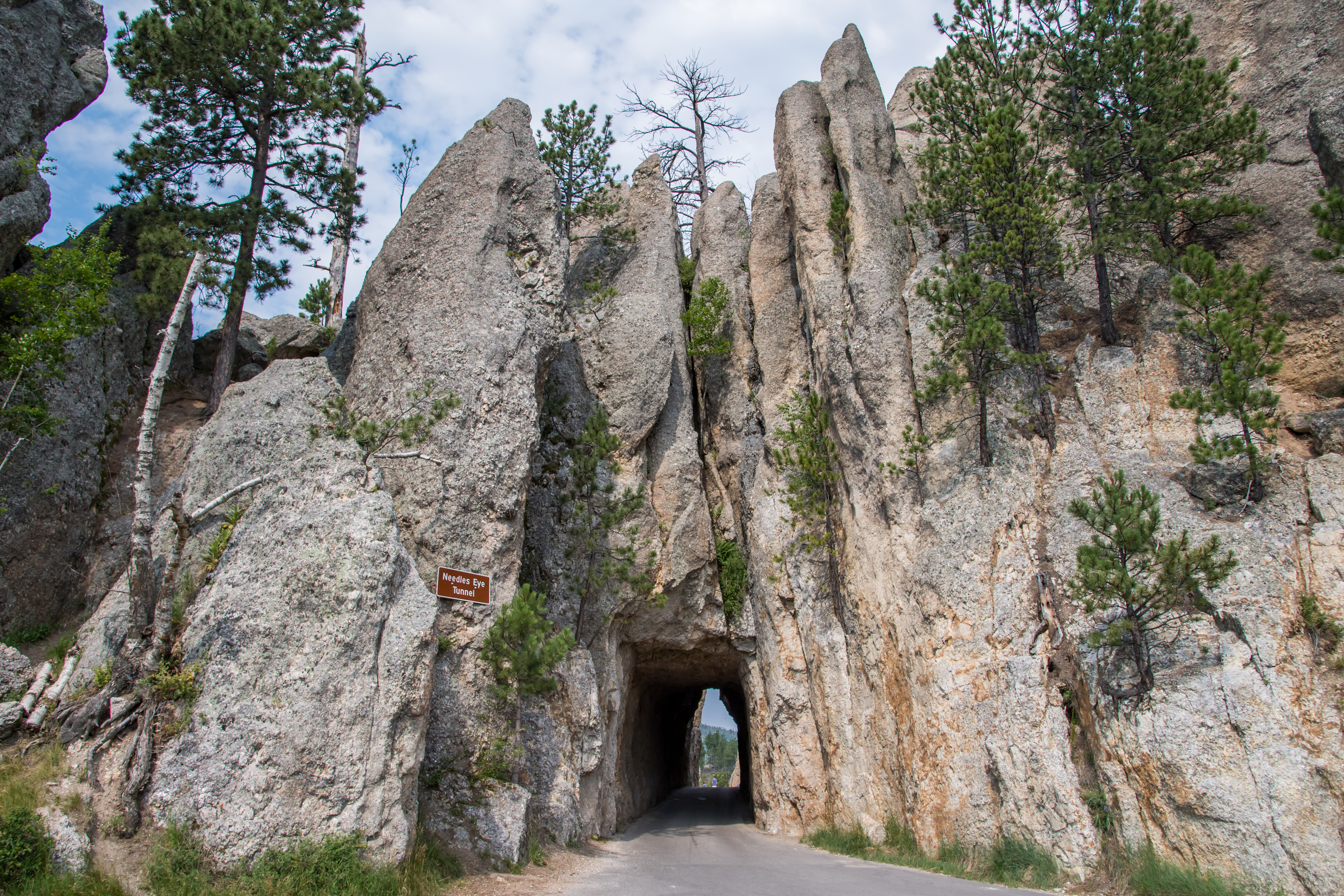 A narrow tunnel surrounded by granite on the Needles Highway in South Dakota