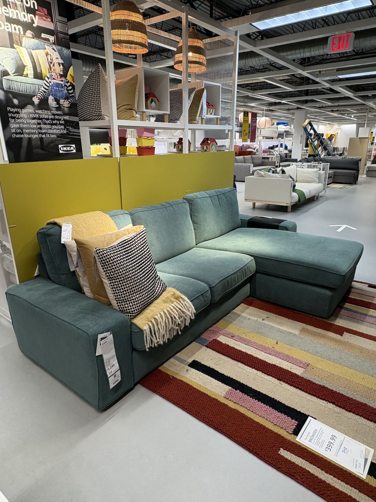 A blue sectional sofa sitting in an IKEA showroom.