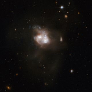 This earlier Hubble Space Telescope view of the celestial object NGC 5256 was released on April 24, 2008, as part of an 18th-anniversary album.