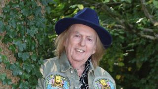 Dave Hill standing next to a tree