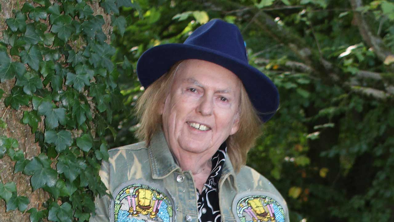 Dave Hill standing next to a tree