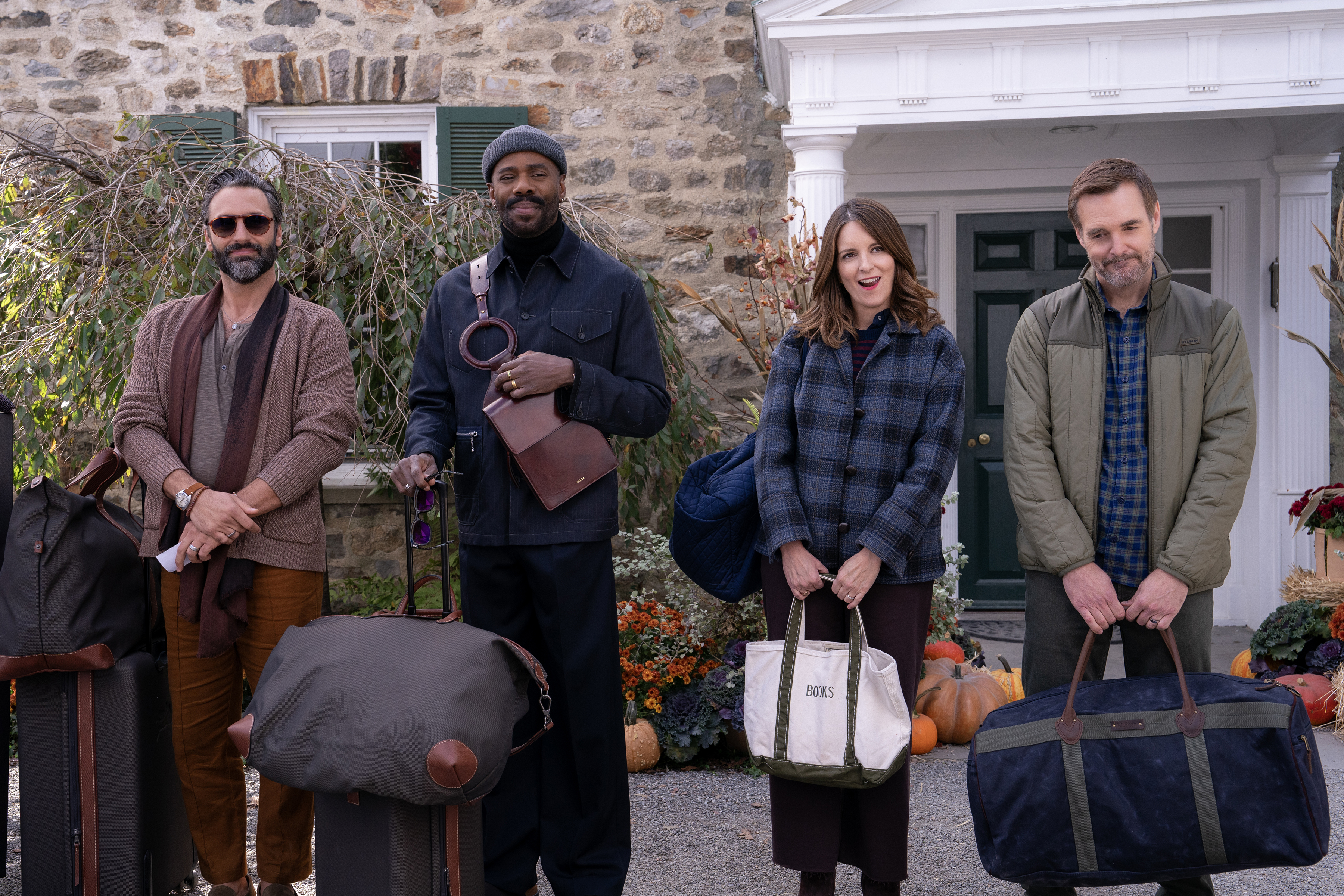 Four people (l-r: Marco Calvani as Claude, Colman Domingo as Danny, Tina Fey as Kate, and Will Forte as Jack) carry luggage while standing outside of a bed and breakfast, in Episode 106 of The Four Seasons.