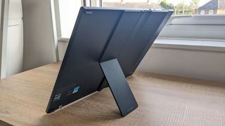 The Asus Zenbook 17 Fold OLED pictured on a wooden desk.
