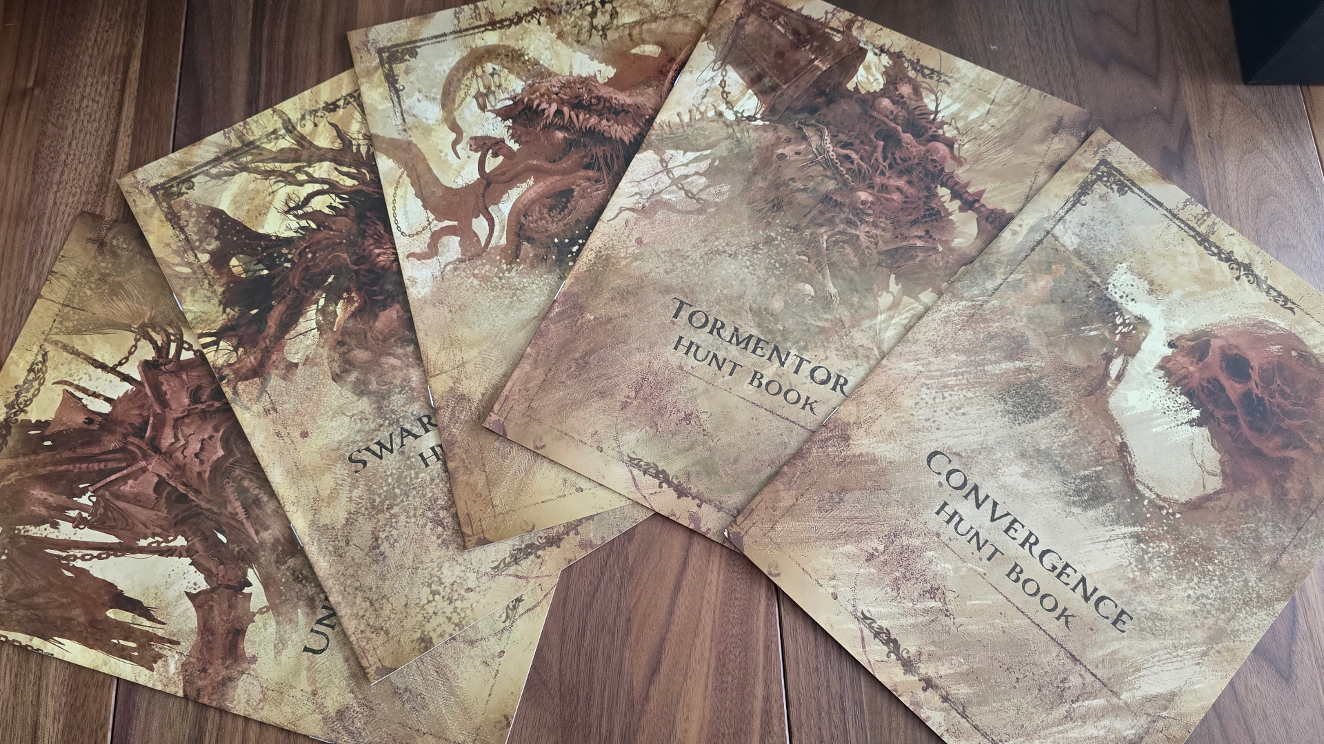 Grimcoven hunt books laid out on a wooden table
