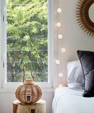original cotton ball fairy lights hanging by a window by a bed - lights4fun