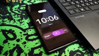 Alarm clock ringing on Android 13 on a Google Pixel 6 on a workstation next to a laptop.