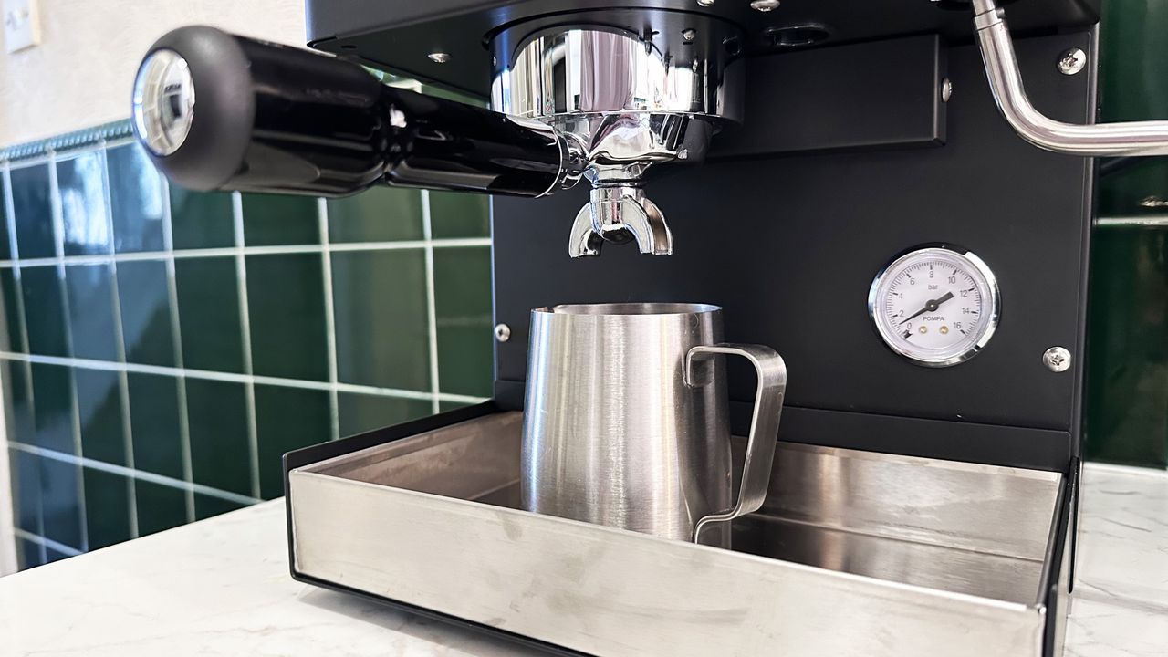 A milk jug sitting in the Diletta Mio's drip tray