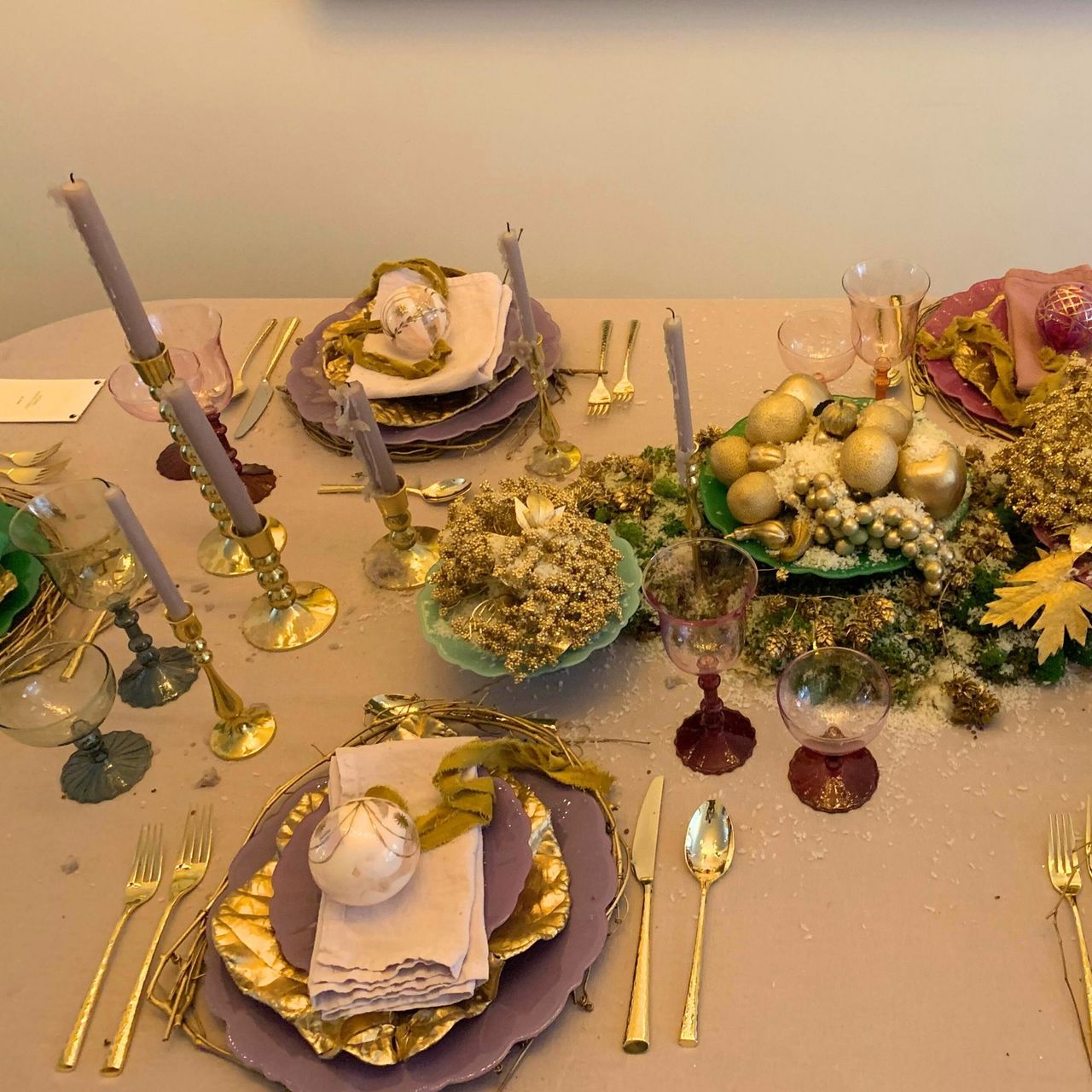 Anthropologie Holiday House dining room table spread with purple table cloth and colorful dishes and glasses