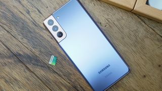 The Samsung Galaxy S21 next to a 256GB microSD card