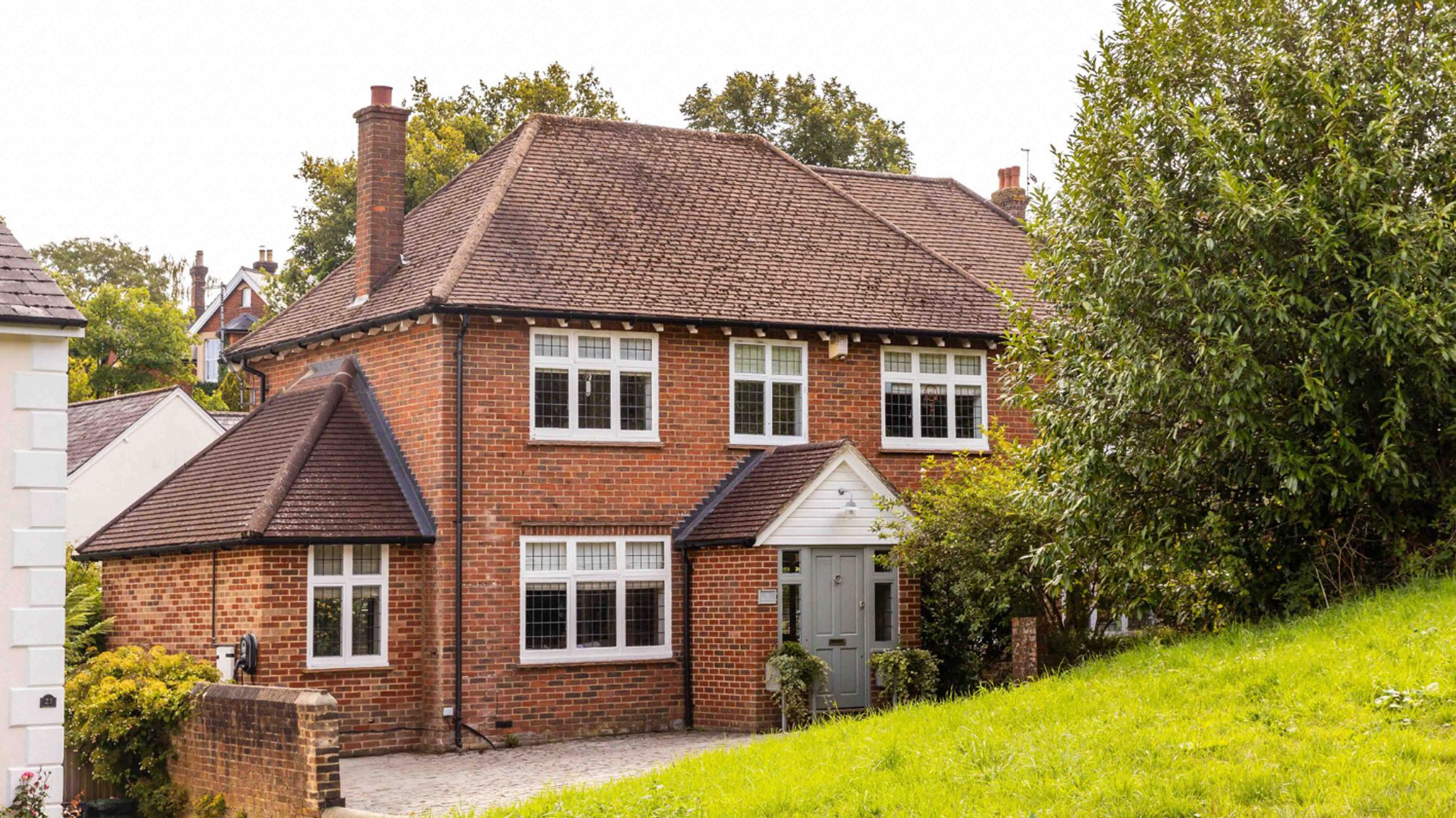 Red bright house with blue front door and pitched roof
