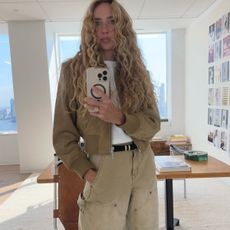 Olympia Gayot wearing a J.Crew suede bomber jacket and J.Crew khaki painter jeans. 