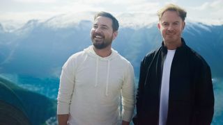 A picture from Martin Compston's Norwegian Fling showing Martin Compston and Phil MacHugh standing somewhere high-up, with snow-capped mountains visible in the mist behind them