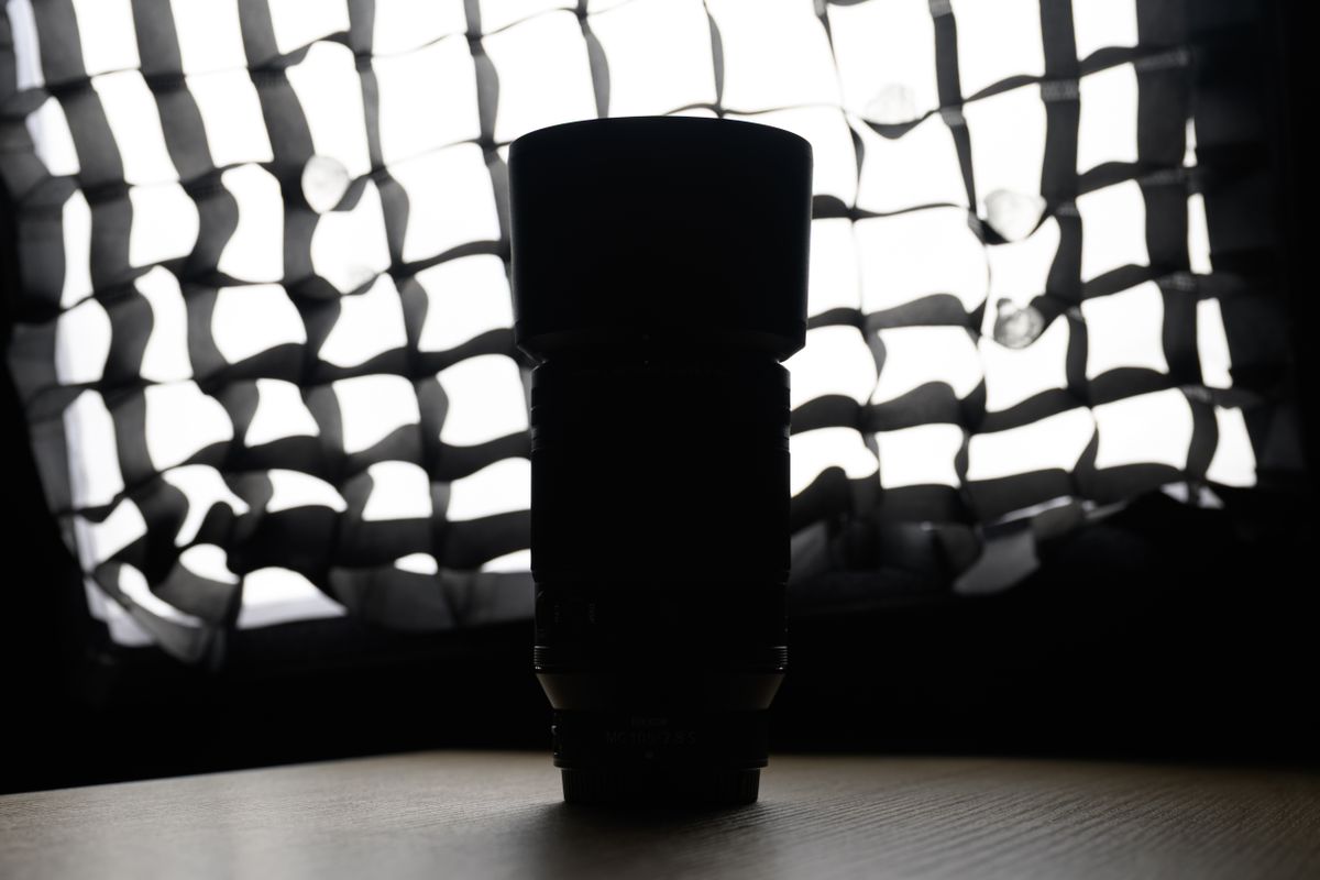 A photo of a backlit Nikon lens