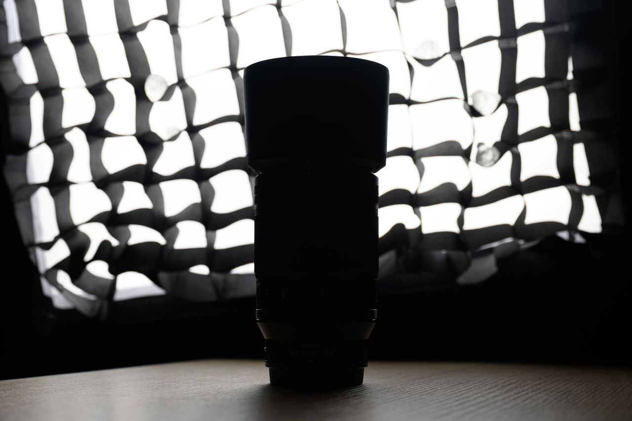 A photo of a backlit Nikon lens