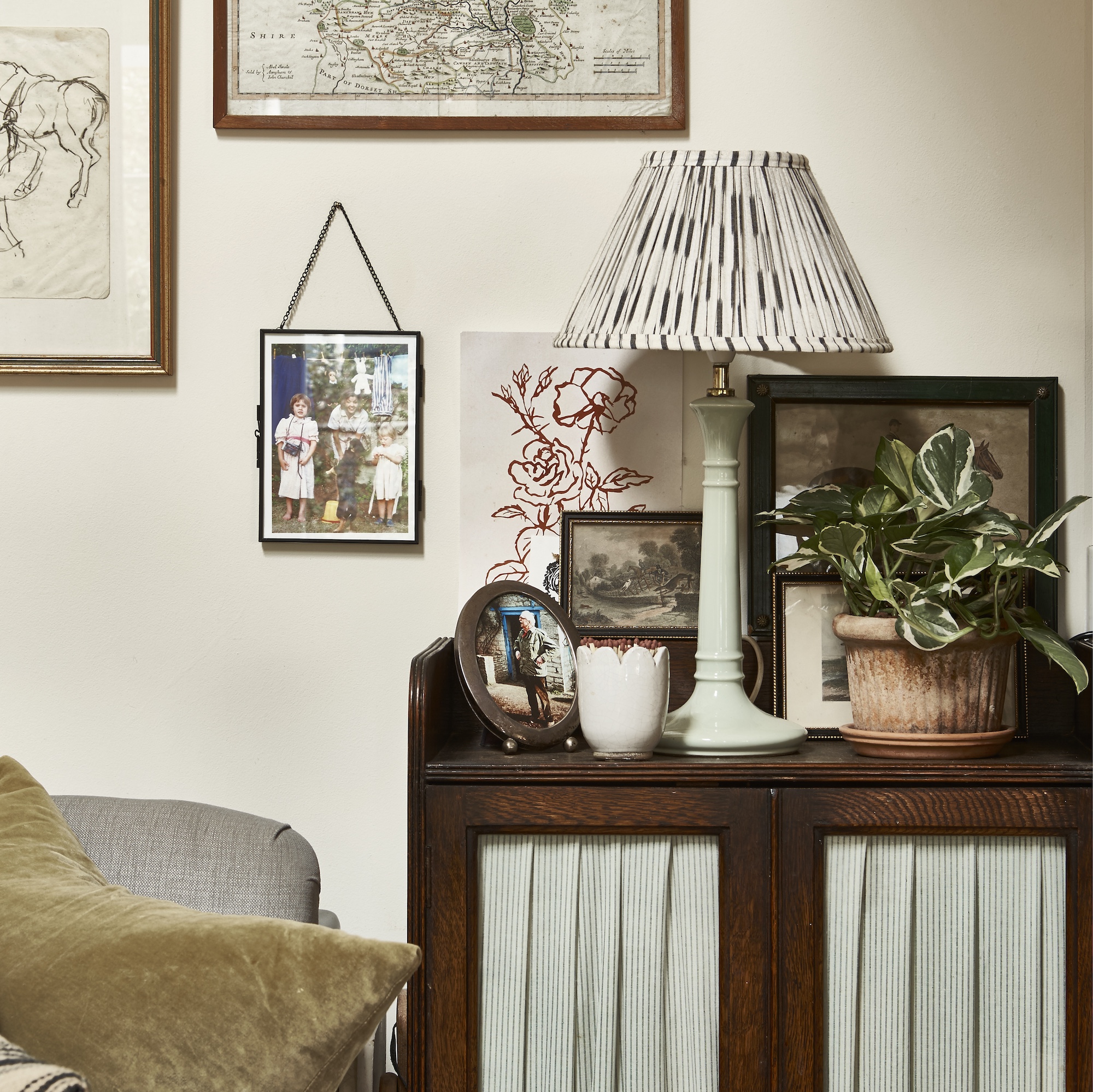 galley kitchen with small island with green metal frame and spiral staircase