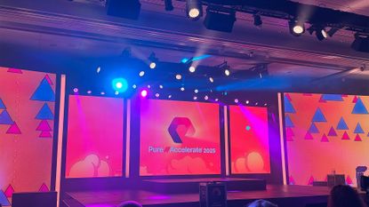 Pure Accelerate logo and branding pictured on the keynote stage at the Resorts World Las Vegas conference center.