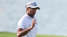 Aaron Rai acknowledges fans at the Abu Dhabi HSBC Championship at Yas Links 
