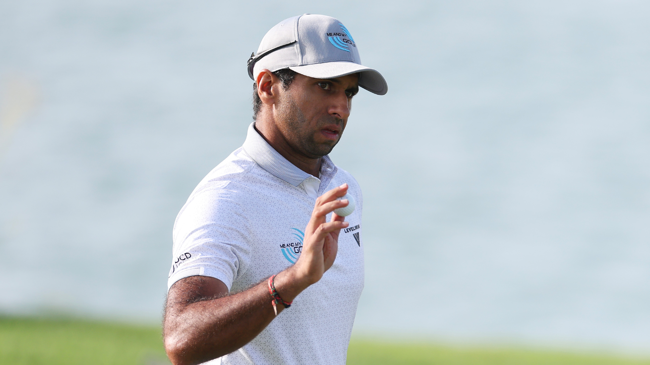 Aaron Rai acknowledges fans at the Abu Dhabi HSBC Championship at Yas Links 