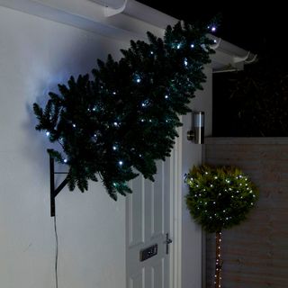 white wall with wall mounted on tree and lighting