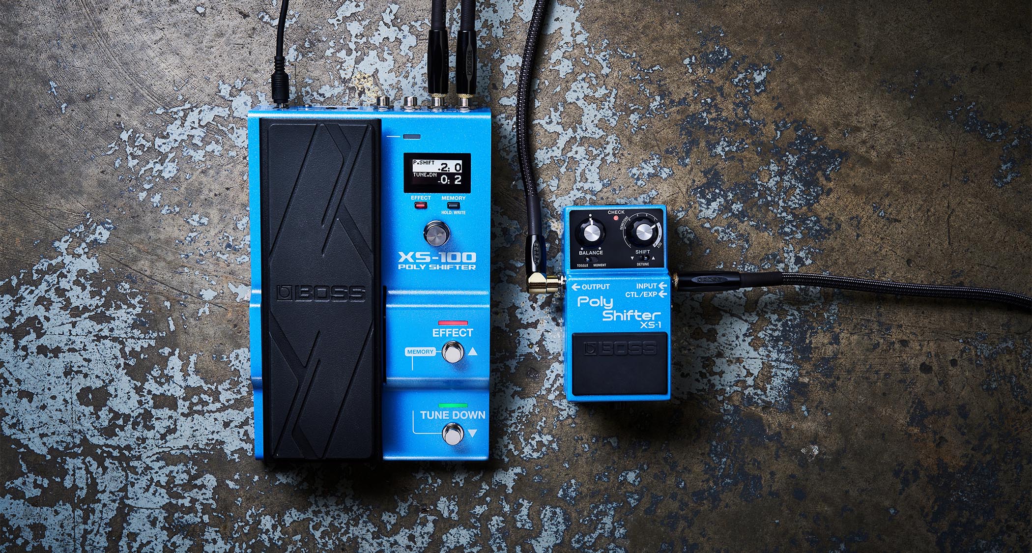 Boss X-100 and XS-1 Poly Shifter: the treadle-equipped XS-100 and Compact Series XS-1 pedal are photographed against an industrial-looking floor.