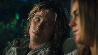 Garrett Hedlund looks over at Lindsay Lohan as they both sit in a truck in Georgia Rule.