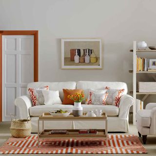 living room with orange door frame and basket