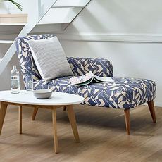 blue chaise lounge with wooden table on floor