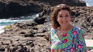 Jane by some rocks for Cape Verde with Jane McDonald.