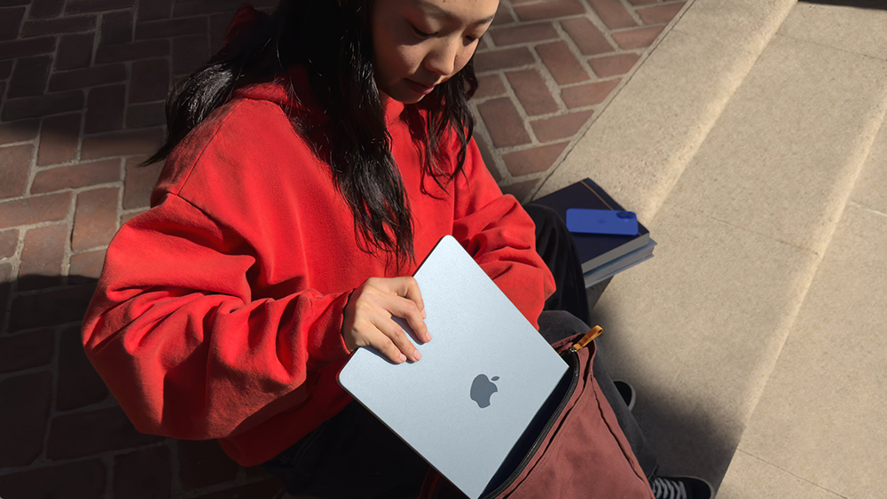 A designer takes a MacBook Air out of her bag