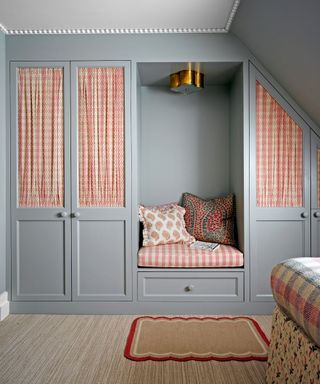 gray cupboards with built in seat and plaid curtains in child's bedroon