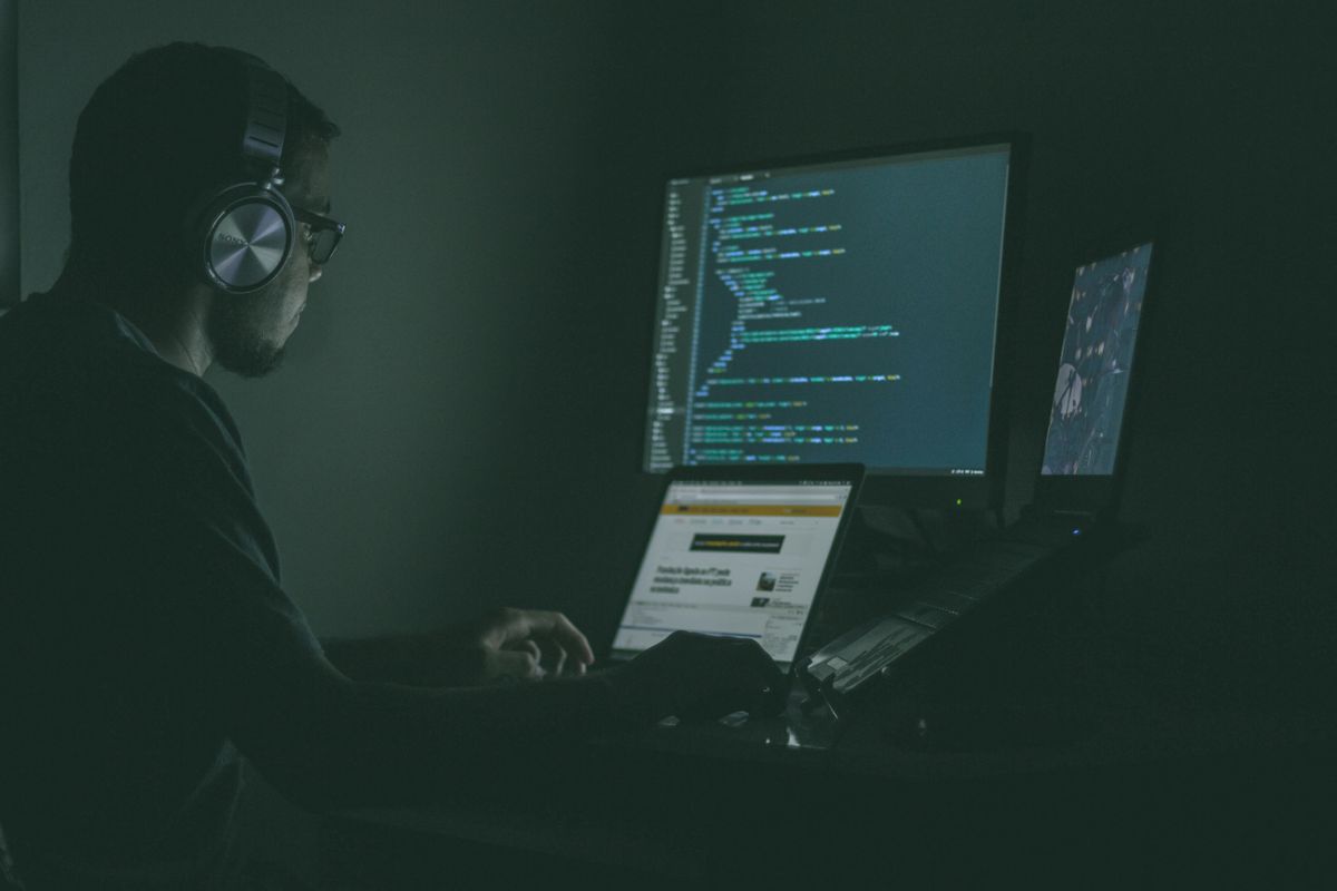 shady person sitting at a computer.