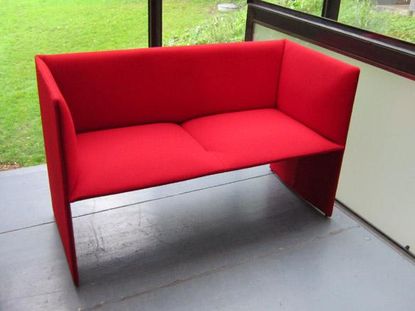 A red sofa in a light background