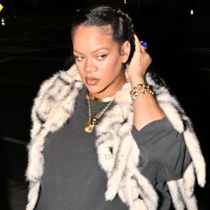 Rihanna signaled the early start of fall fashion with a fur shawl in LA