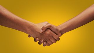 two people shaking hands against yellow background