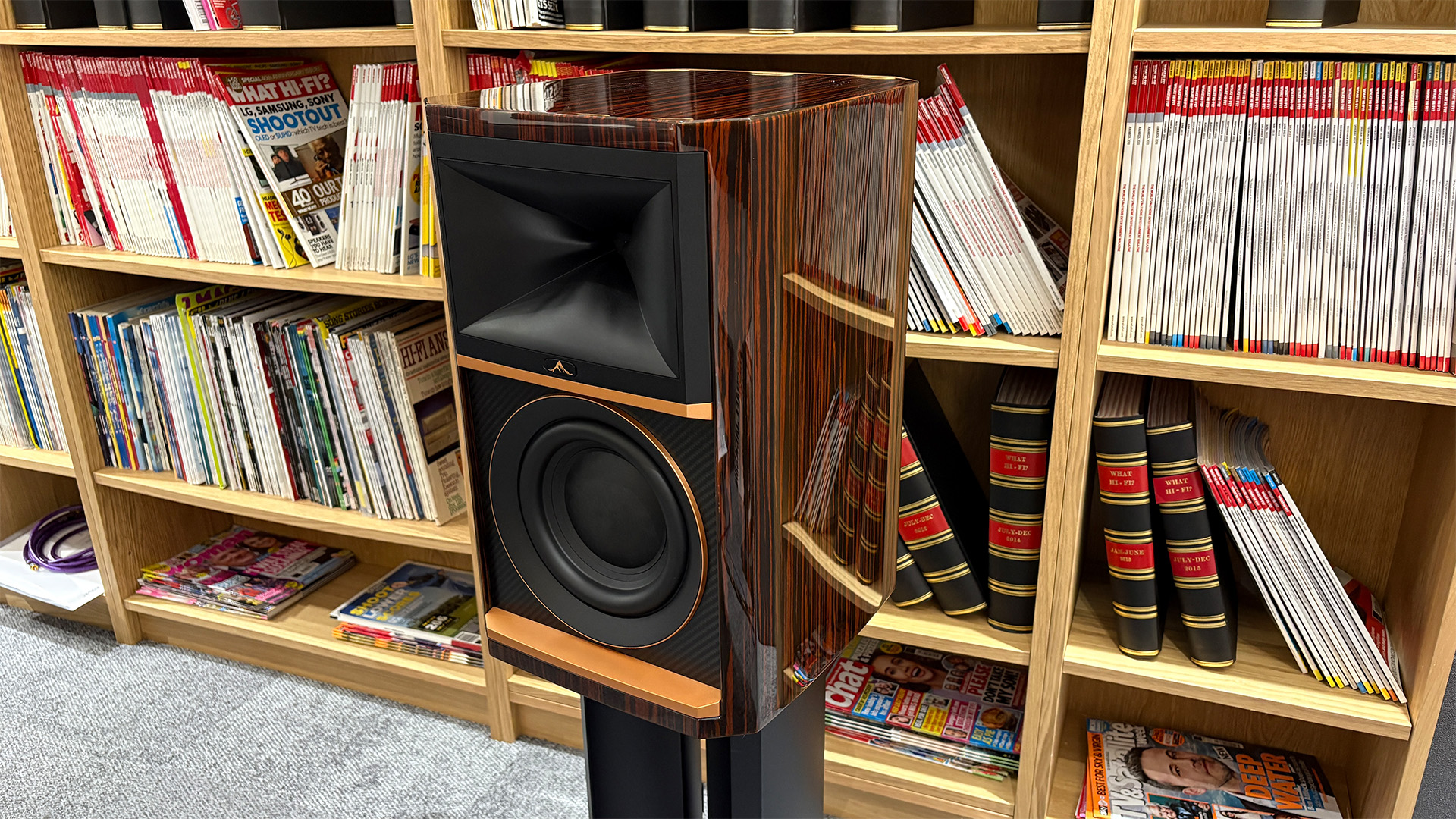 JBL Summit Ama standmount speaker in front of bookcase