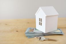 Rendering of a model house on a pile of US currency