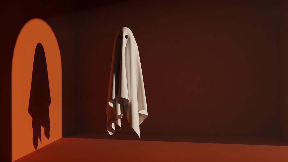 Ghost in front of light with a silhouette on orange background