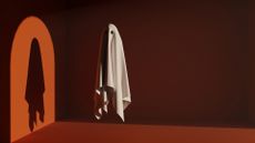 Ghost in front of light with a silhouette on orange background