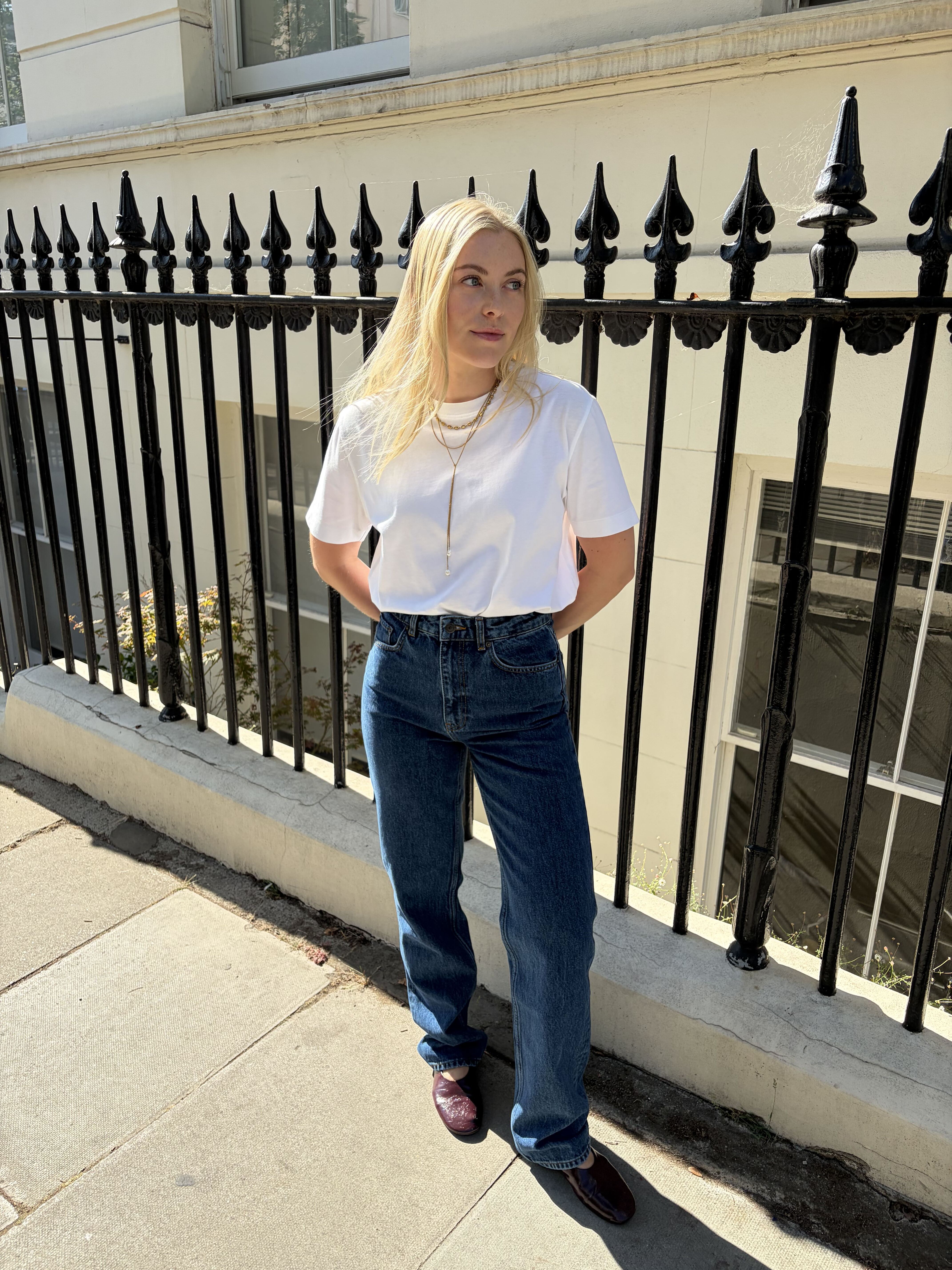 Shopping Editor Florrie wearing straight-leg blue jeans and white tee.