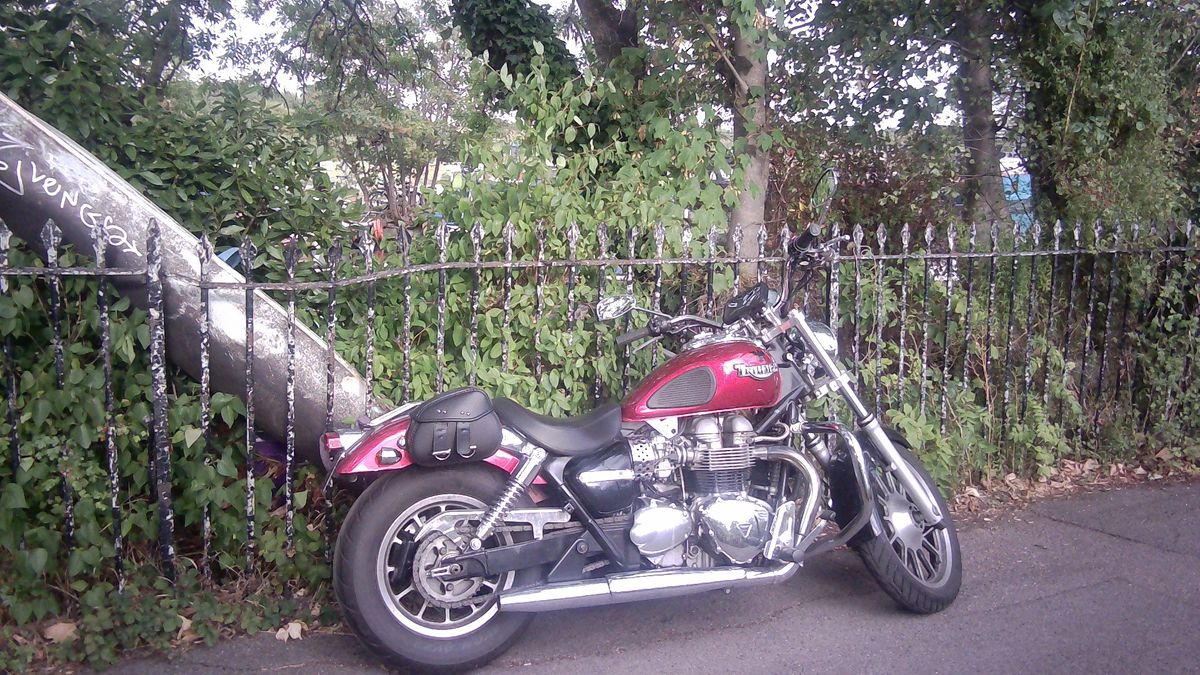 Sample image taken with Godox C100 showing red Triumph motorcycle