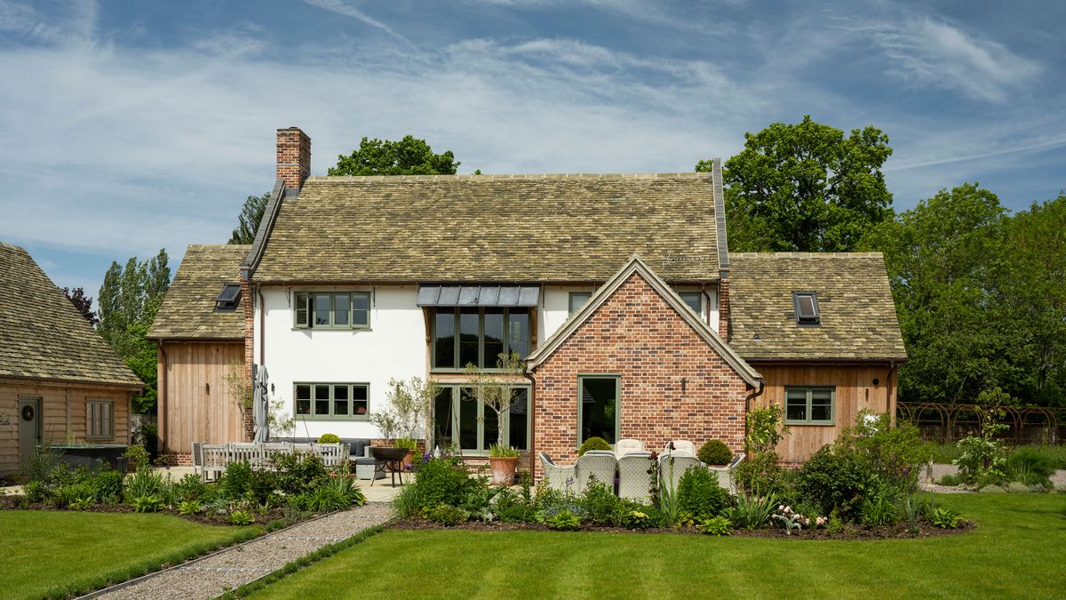 oak frame house with white render and timber cladding