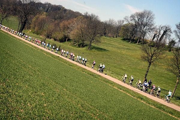 The peloton strung out single-file through the Dutch country side.