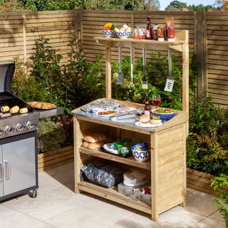 simple wooden outdoor kitchen unit with bbq