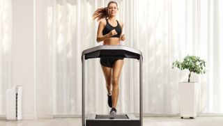 a woman running on a treadmill