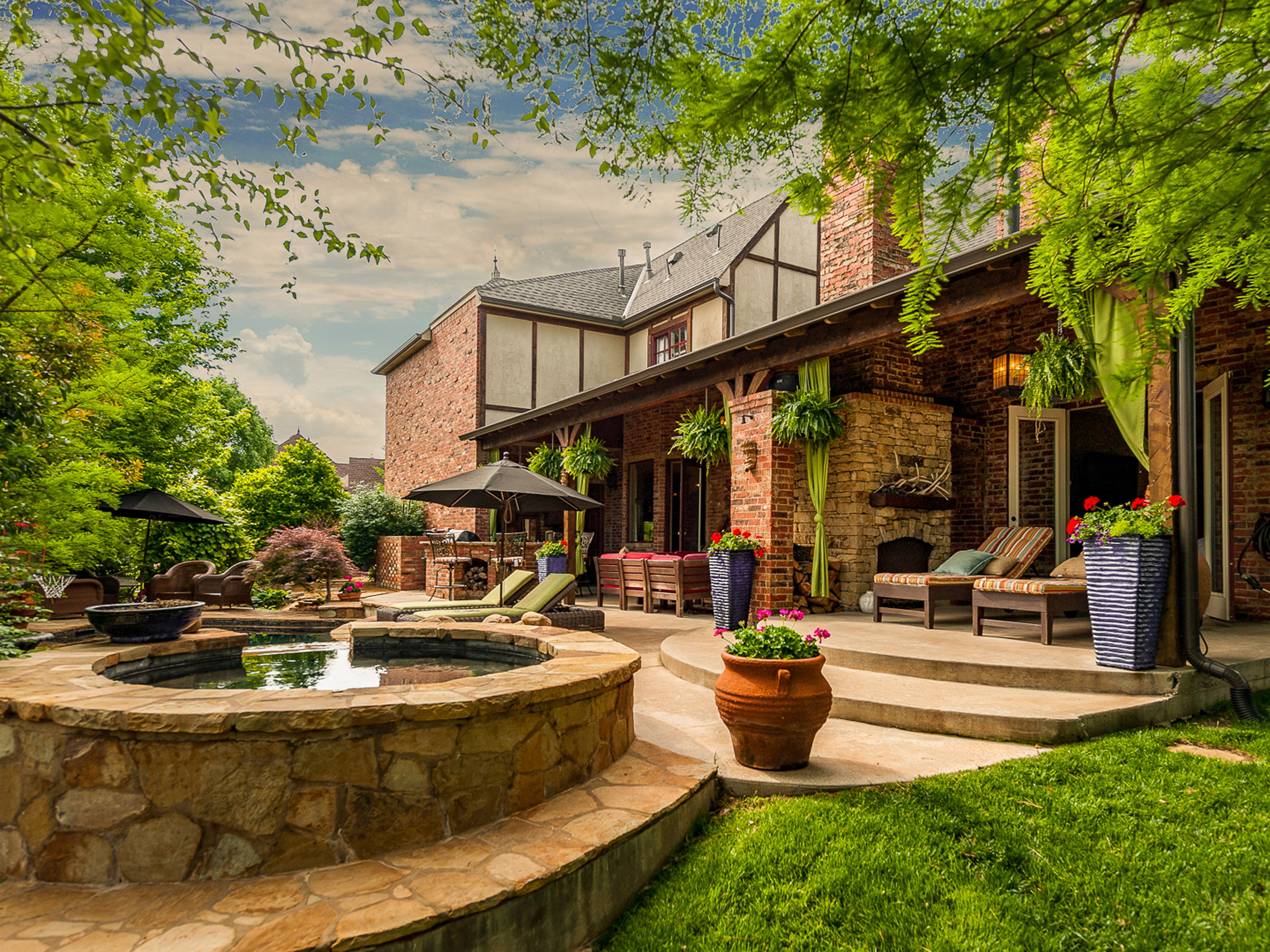 pool landscaping ideas: backyard with stone paving and stone walls surrounding a plunge pool